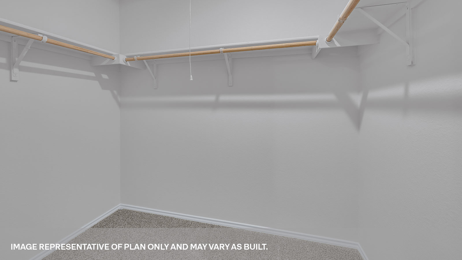 Main bedroom closet with wooden shelving and carpeting.