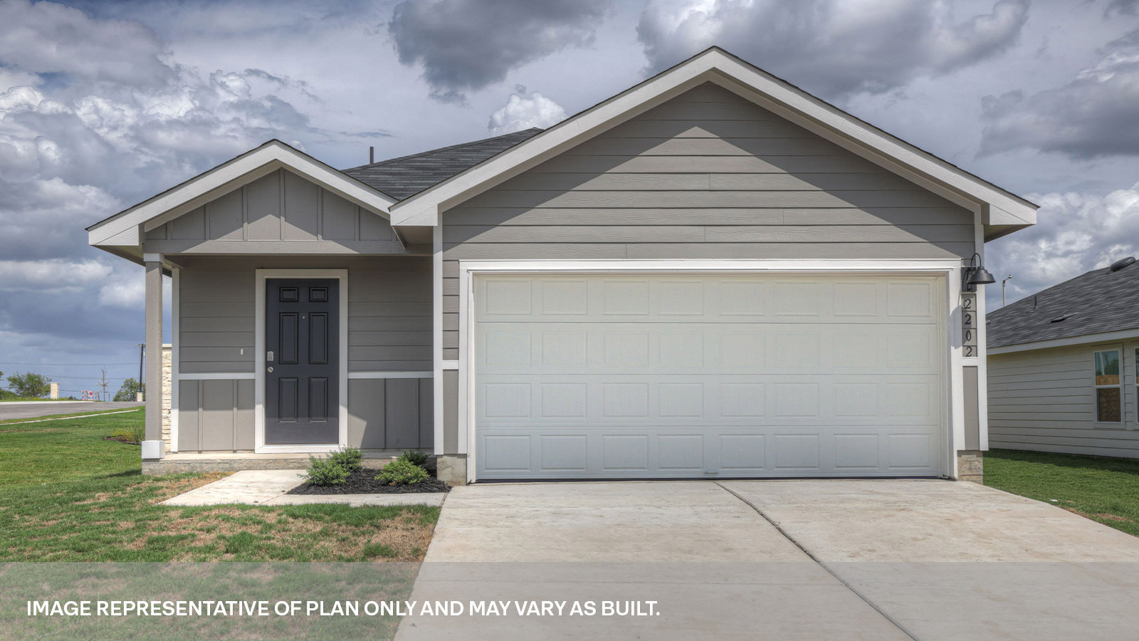 Single-story farmhouse exterior with 2 car garage and two windows.