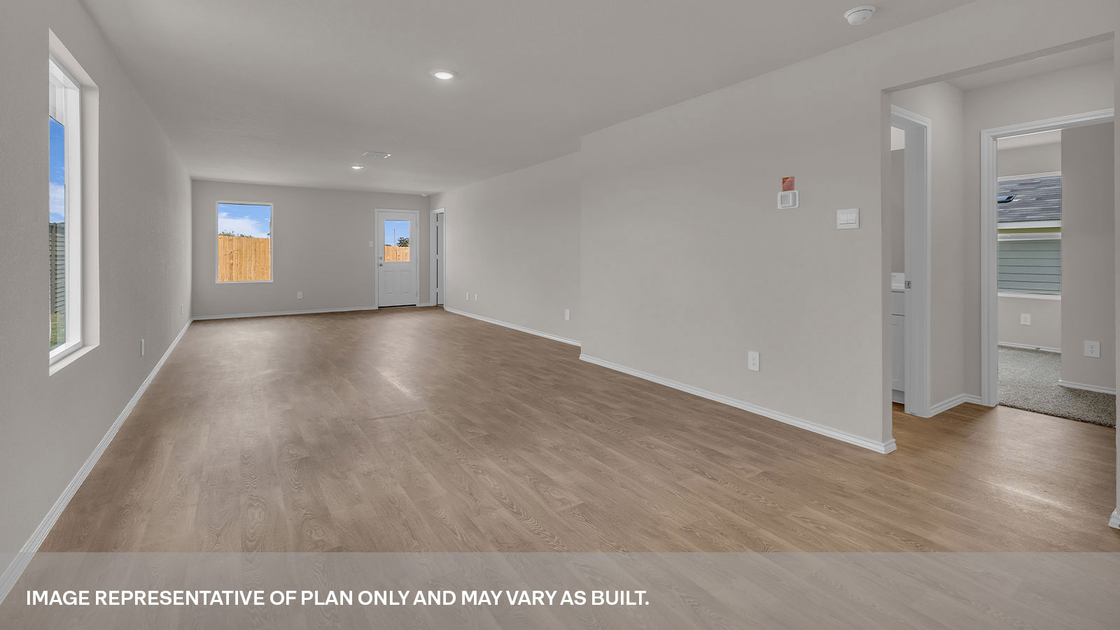 Dining room with vinyl flooring and opening to the living room.