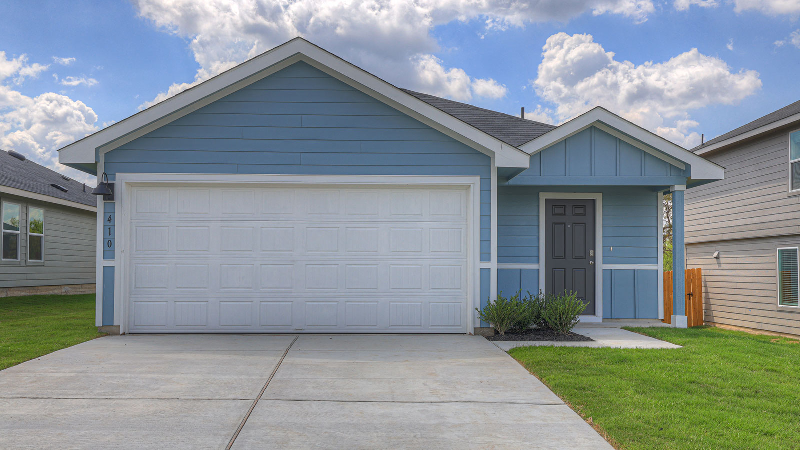 Single-story farmhouse with 2 car garage.
