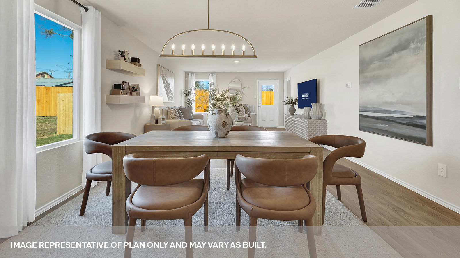 Dining room and living room featuring two windows and a door to the back yard