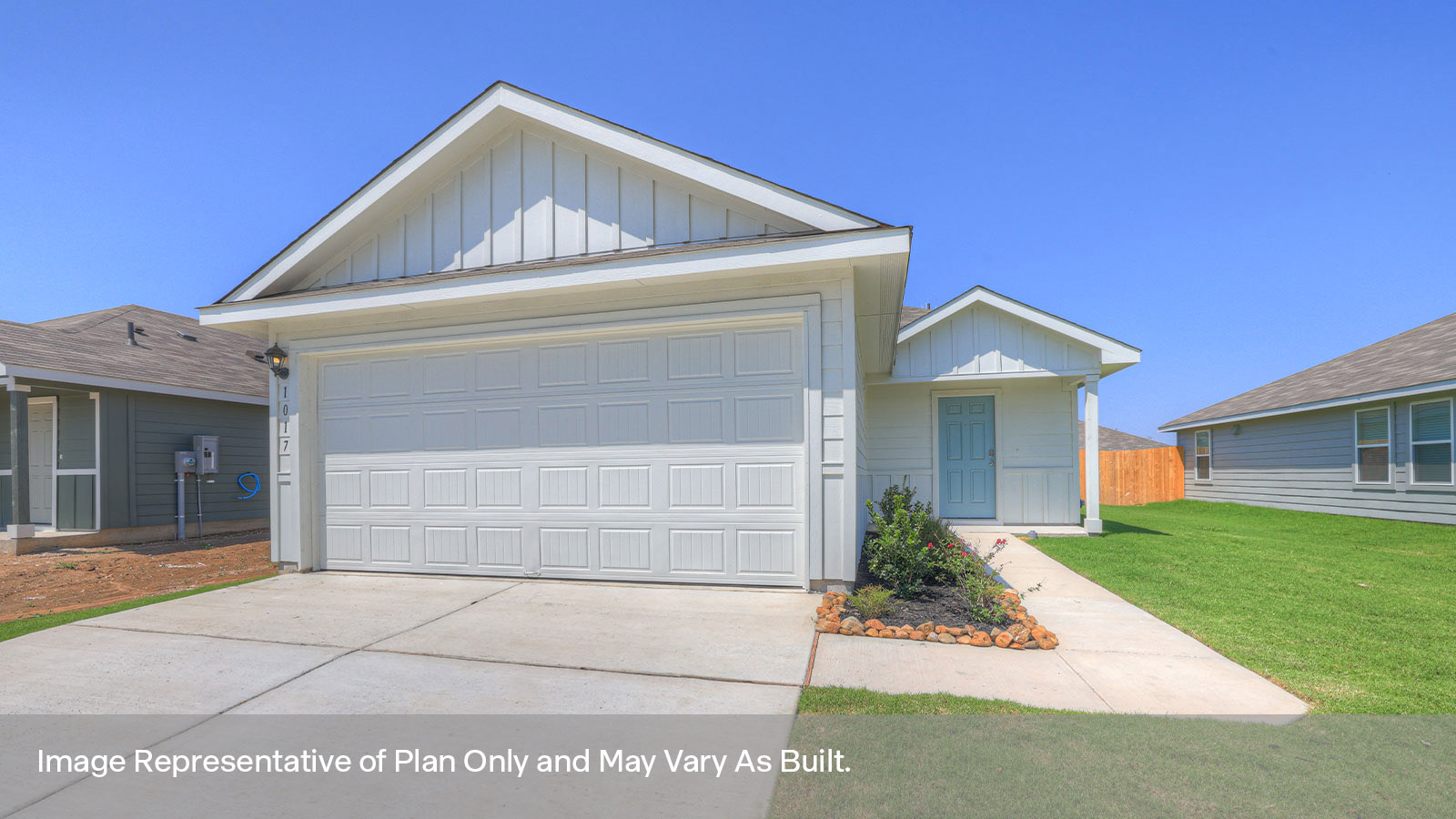 two car garage, siding and a wrap around sidewalk to the front entry