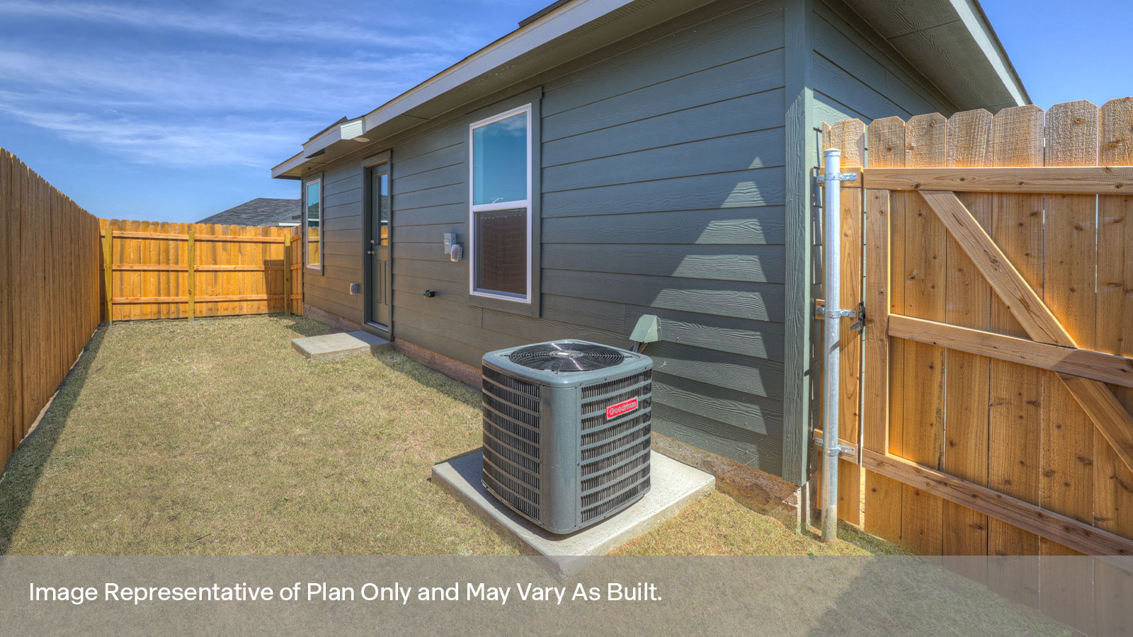 Backyard with 2 windows, and a half lite exterior door.