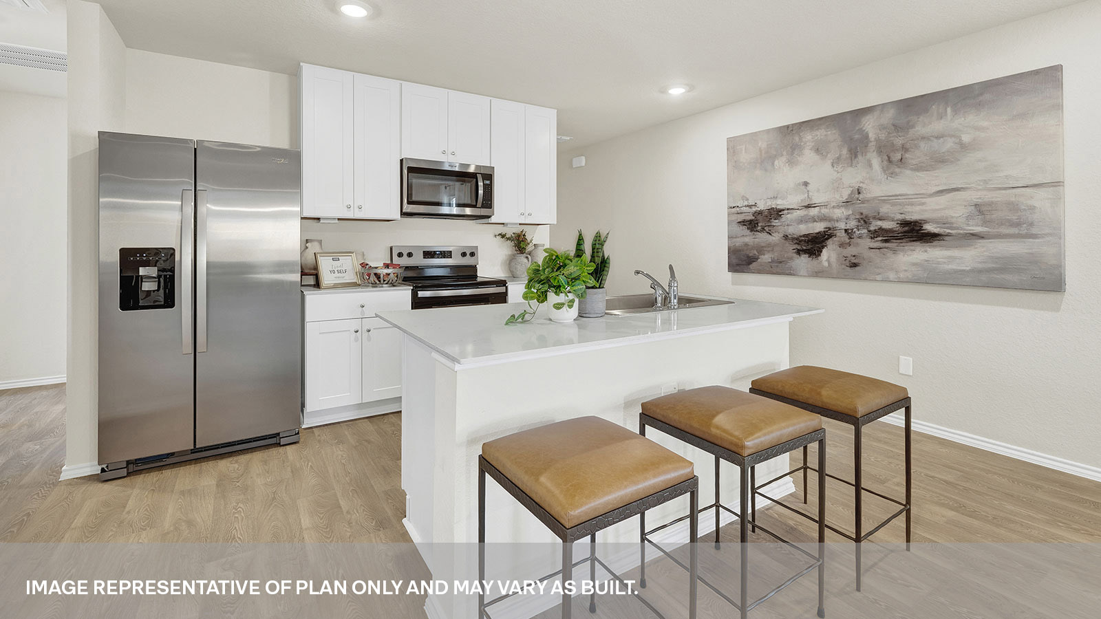 Kitchen with kitchen island and white cabinets.