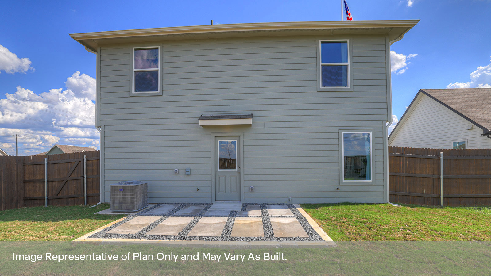 Backyard patio with sod and privacy fence.