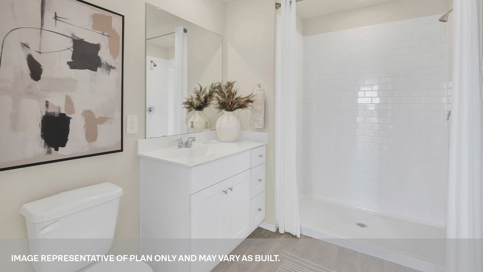 Primary bath room featuring an extended vanity, walk in shower with tile surround.