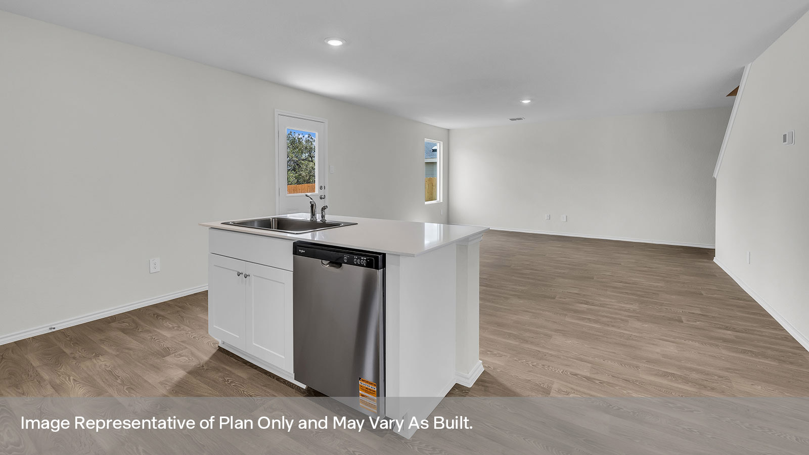 Kitchen island with quartz countertops and stainless steel appliances.