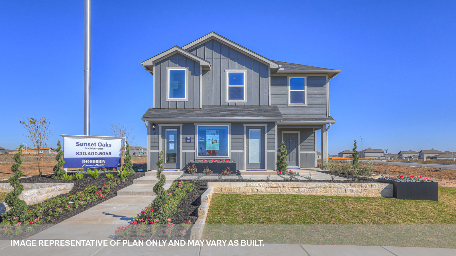 Two-story farmhouse exterior with 2 car garage.