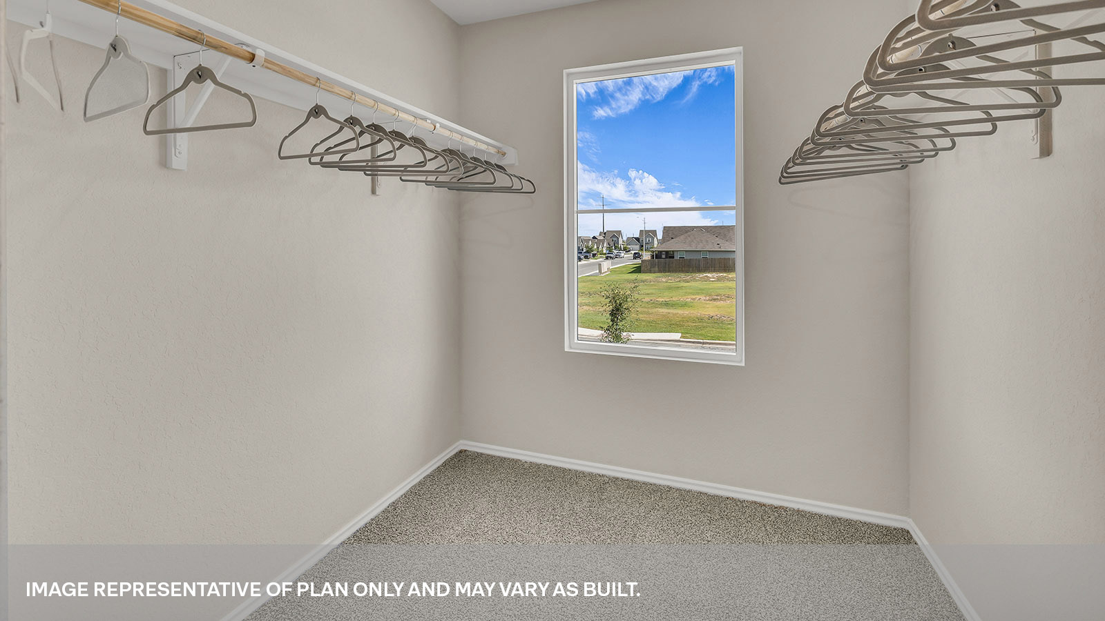 Main bedroom closet with carpeting and wooden shelving.
