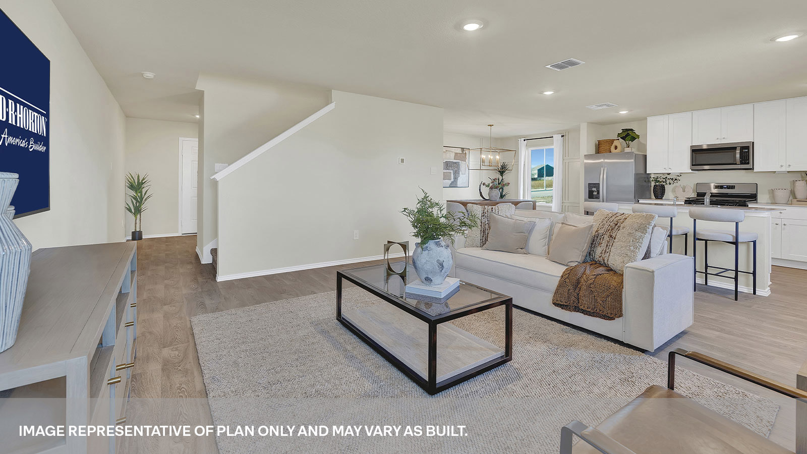 Living room with vinyl flooring leading to the staircase to the 2nd floor.