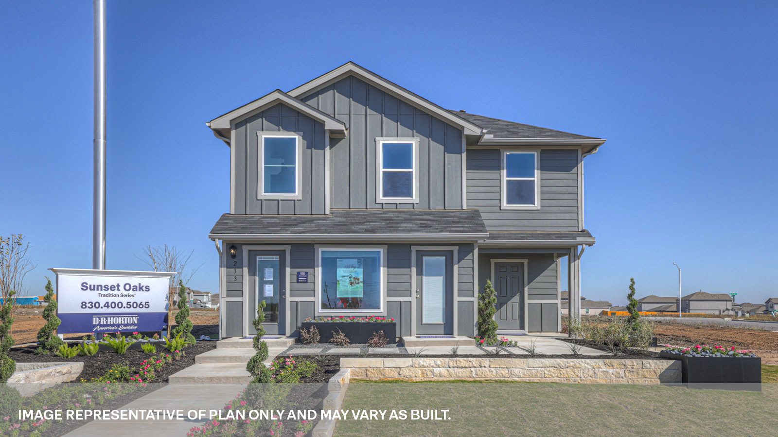Two-story farmhouse exterior with 2 car garage.