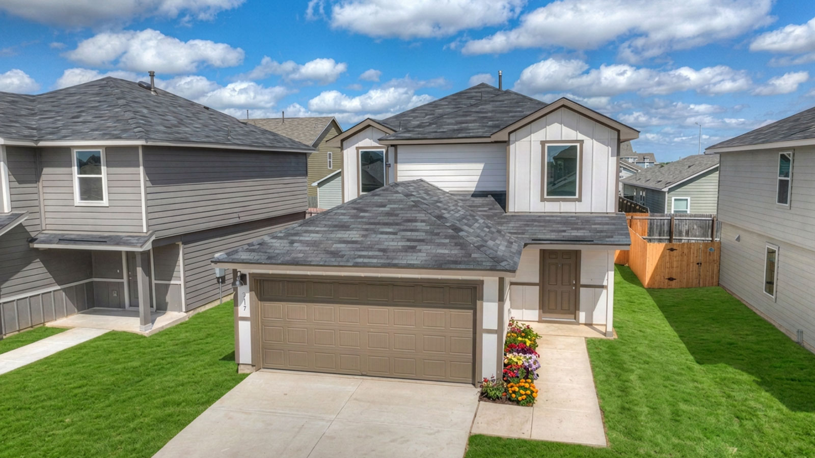 Two-story farmhouse exterior photo with 2 car garage.
