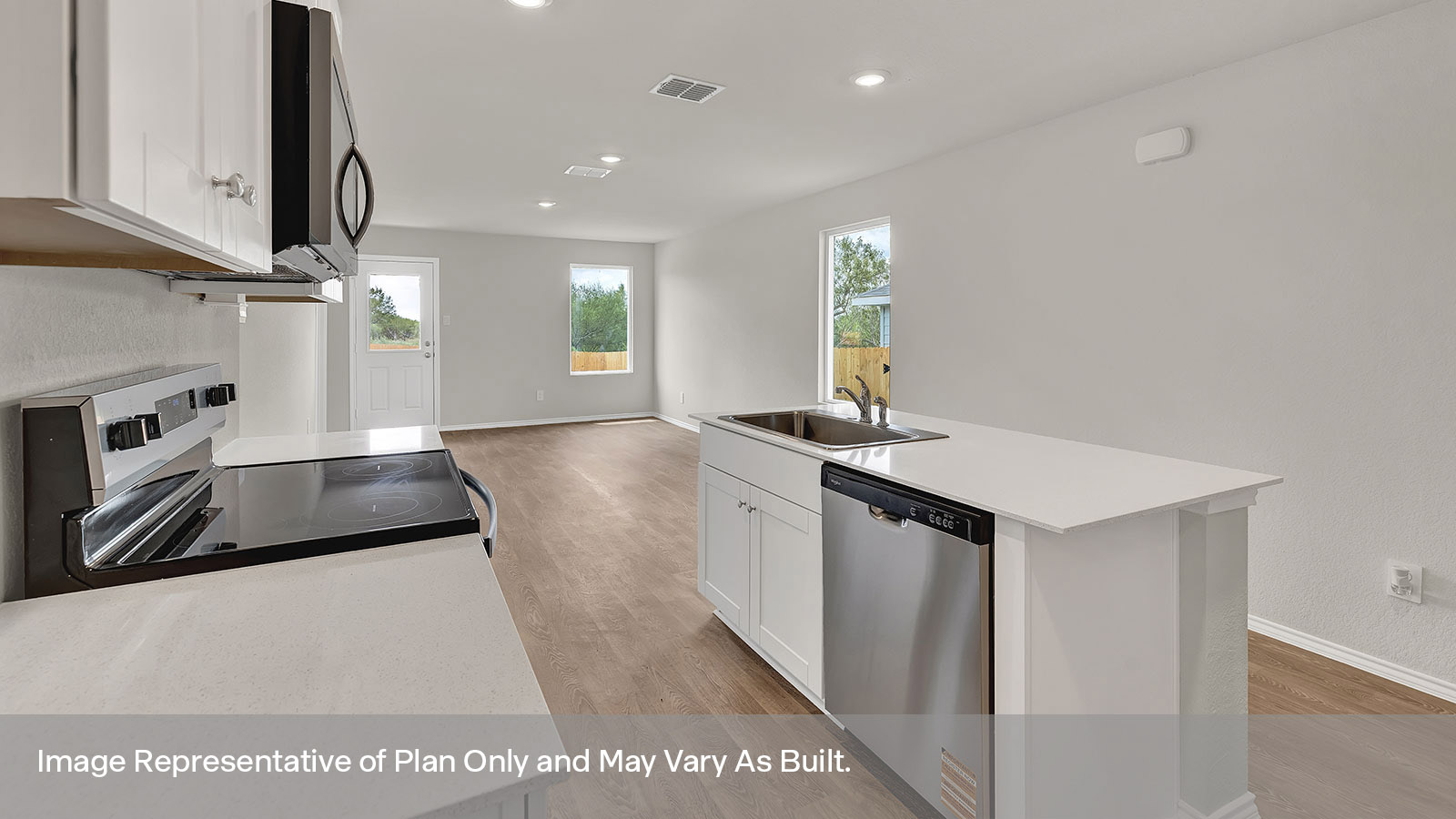 Kitchen with kitchen island and entry hallway.