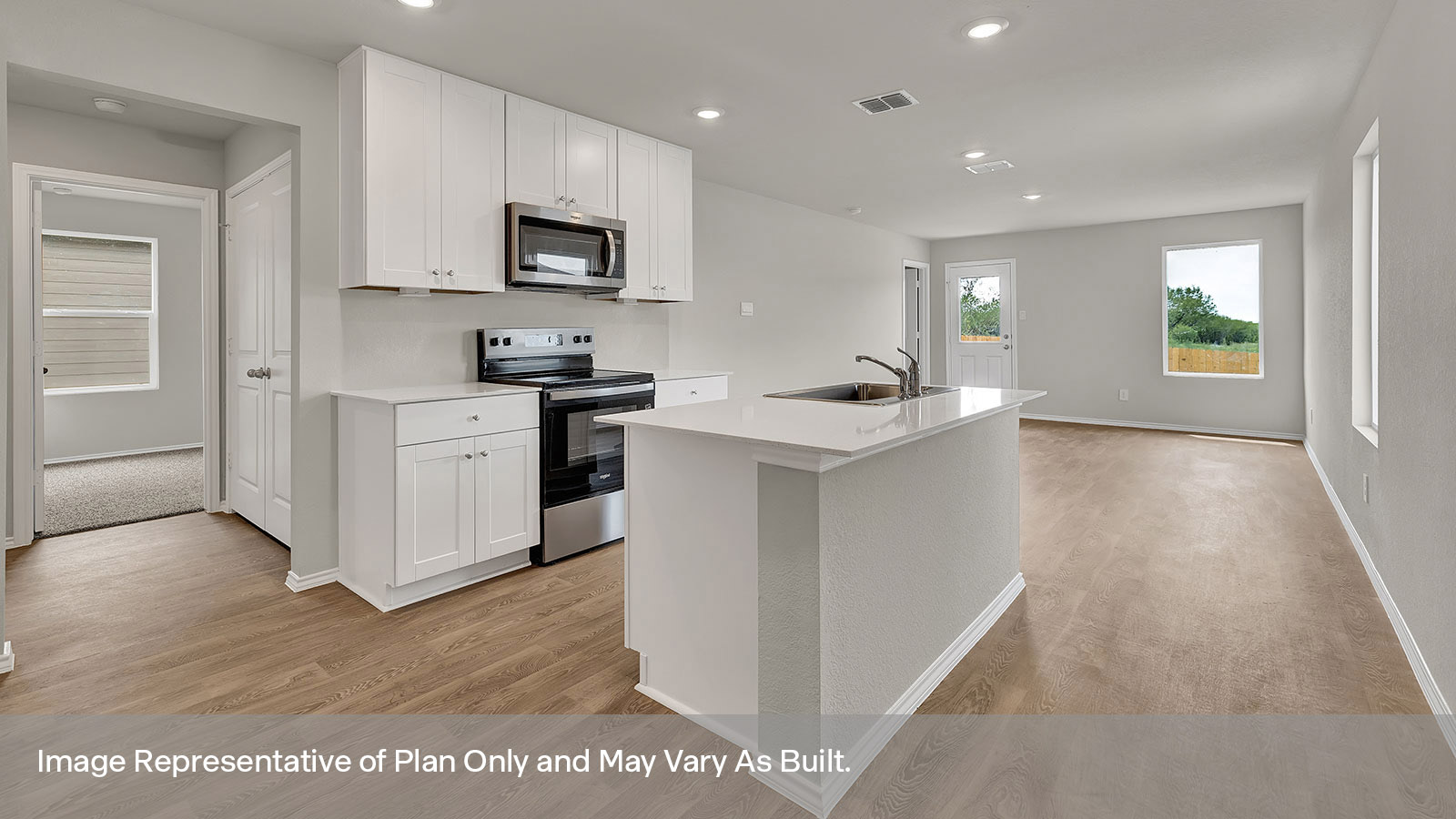 Kitchen with kitchen island and entry hallway.