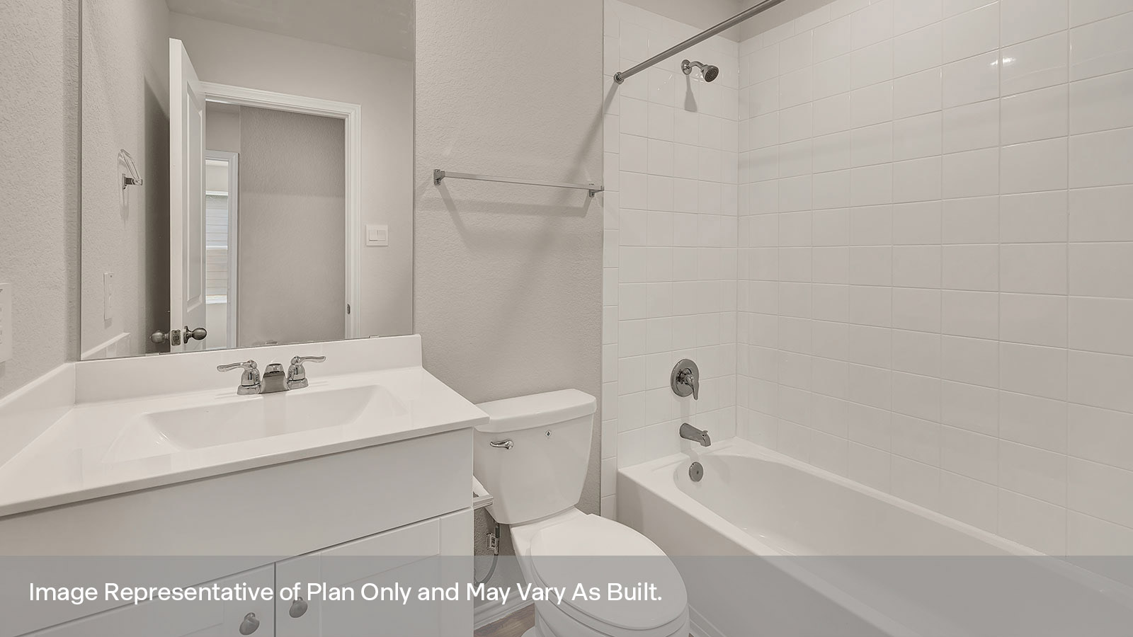 Hall bathroom with single-sink vanity, toilet, and tub with tile surround.
