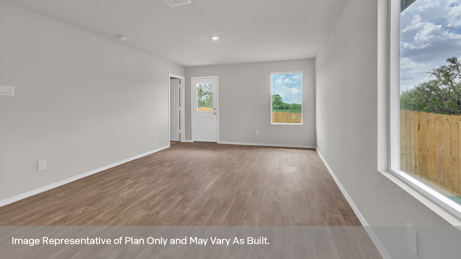 Living room with vinyl flooring opening to the kitchen.