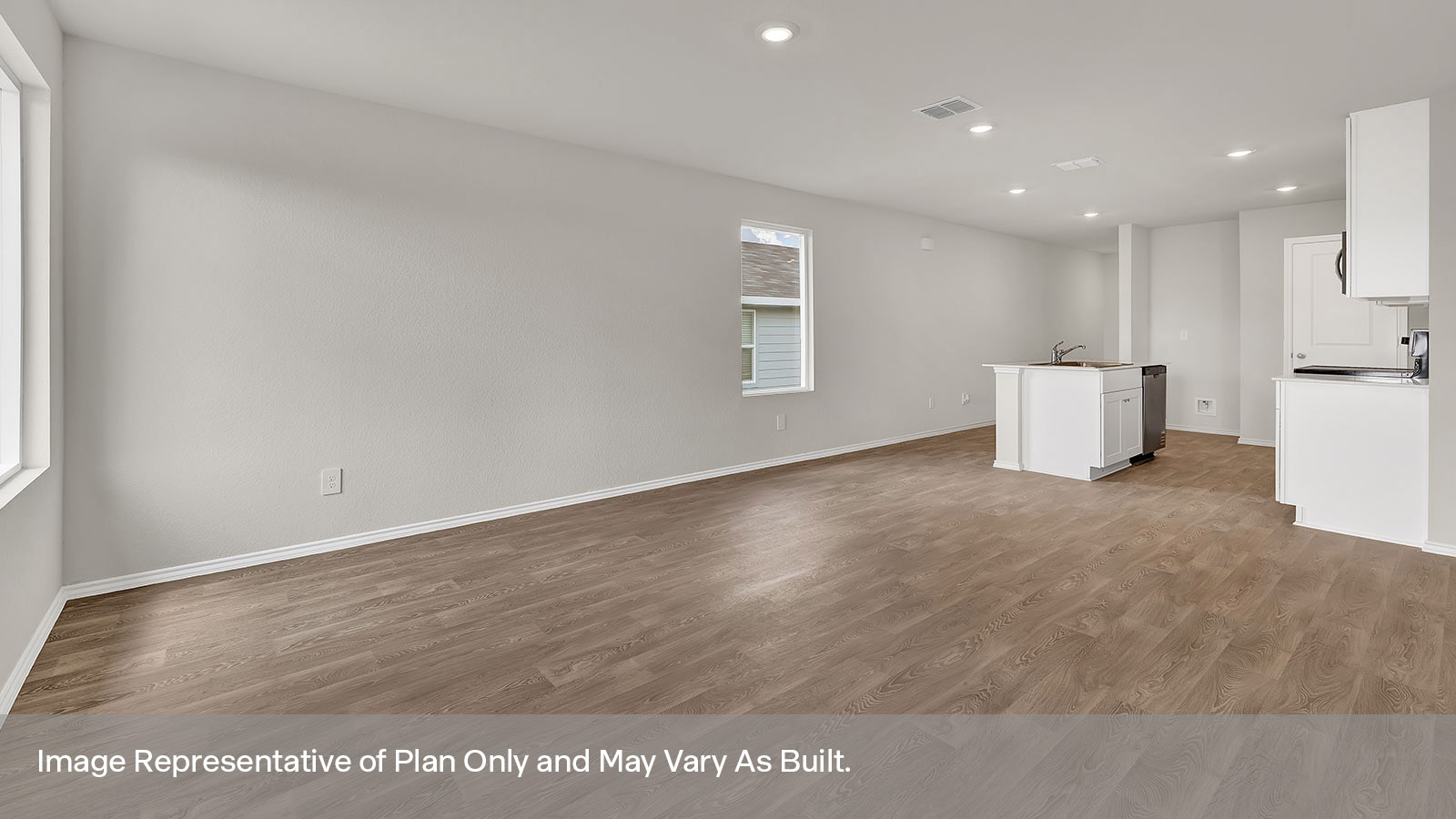 Living room with vinyl flooring opening to the kitchen.