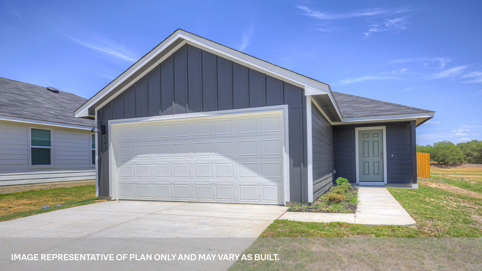 Single-story farmhouse with 2 car garage.