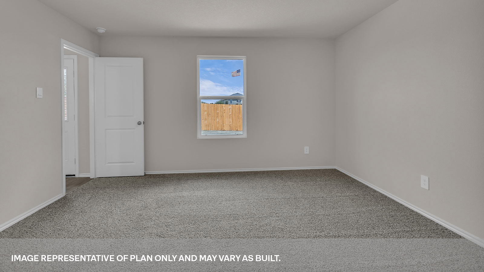 Main bedroom with carpeting and bathroom entry.