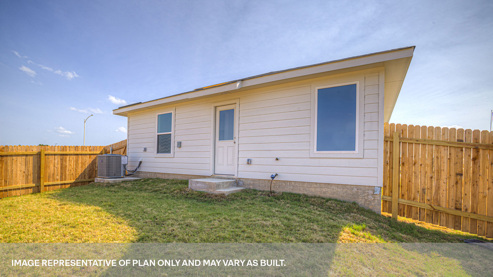 Backyard with 2 windows, and a half lite exterior door.