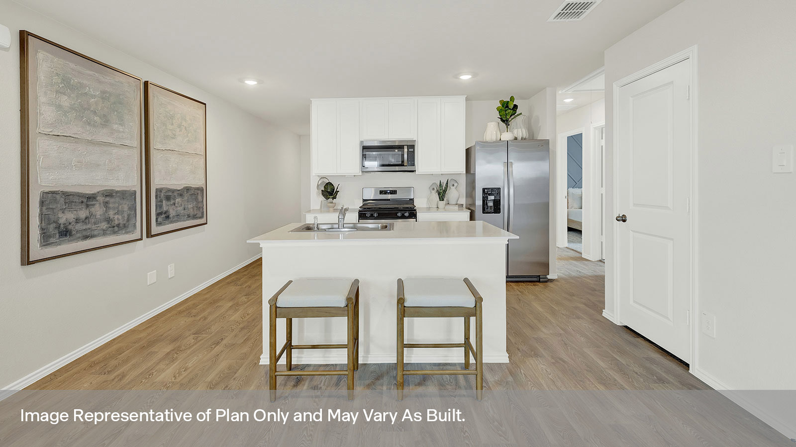 Kitchen with kitchen island and white cabinets.