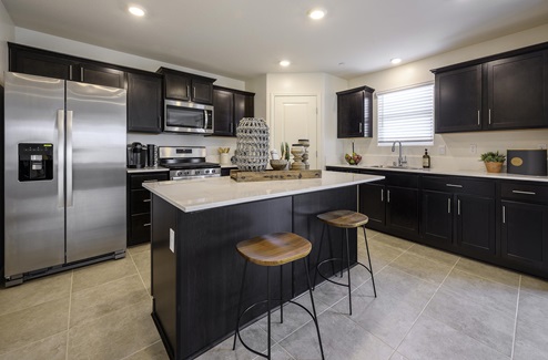 Kitchen with dark cabinetry and island seating