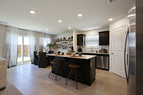 Kitchen with brown cabinets and island seating