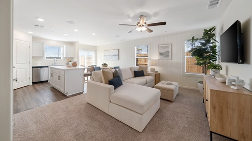 Interior photo of living room with white sectional couch and wood furniture peices