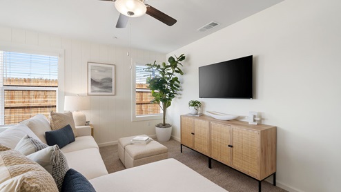 Interior photo of living room with white sectional couch and wood furniture peices