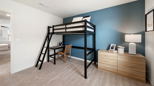 Interior photo of kid's bedroom with lofted bed and dresser