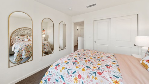 Interior photo of a kid's bedroom with mirrors on the wall
