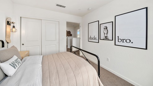 Interior photo of a bedroom with black and white art of the wall