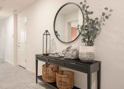 Interior photo of entryway to home with entry table and decor.