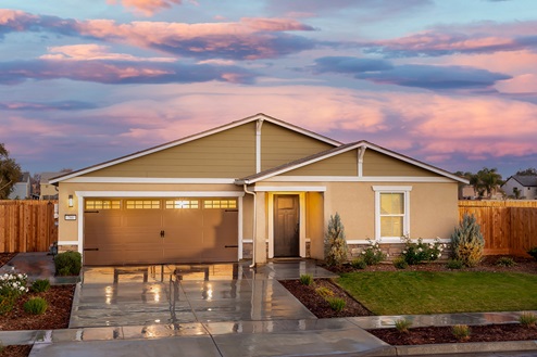 Exterior photo of one story house with two car garage.