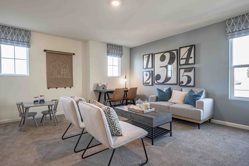 Interior photo of upstairs loft with couches and coffee table.