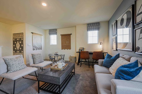 Interior photo of upstairs loft with couches and coffee table.