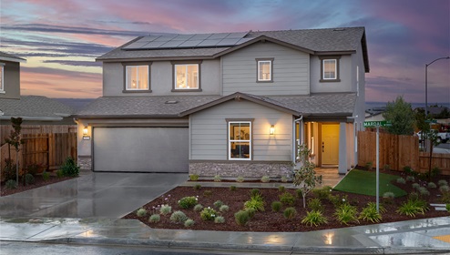 Exterior photo of two story home with two car garage.