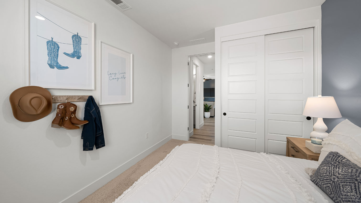 Bedroom with plush carpeting, sliding closet doors, and doorway to hallway