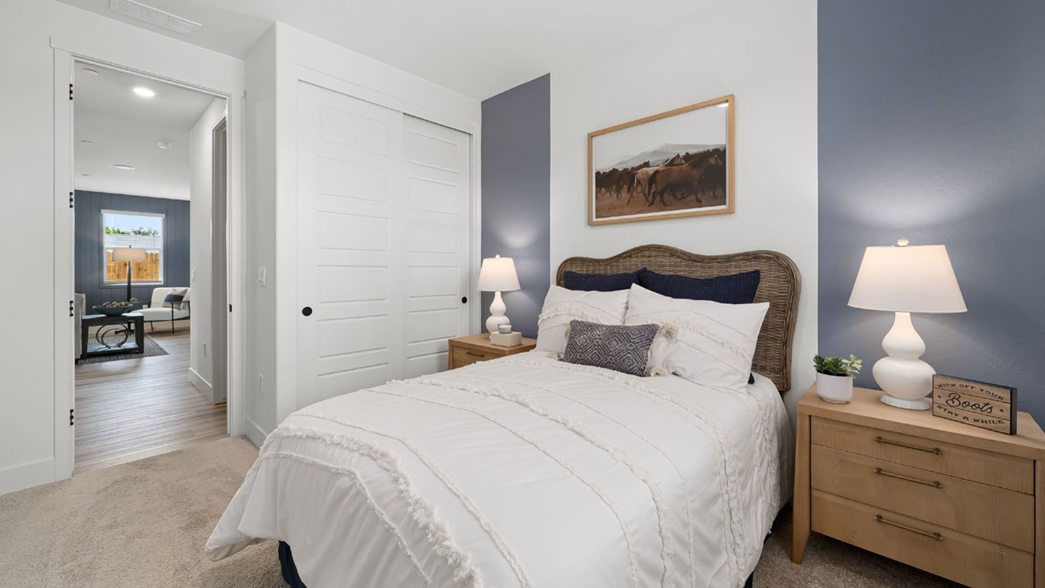 Bedroom with plush carpeting, sliding closet doors, and hallway access
