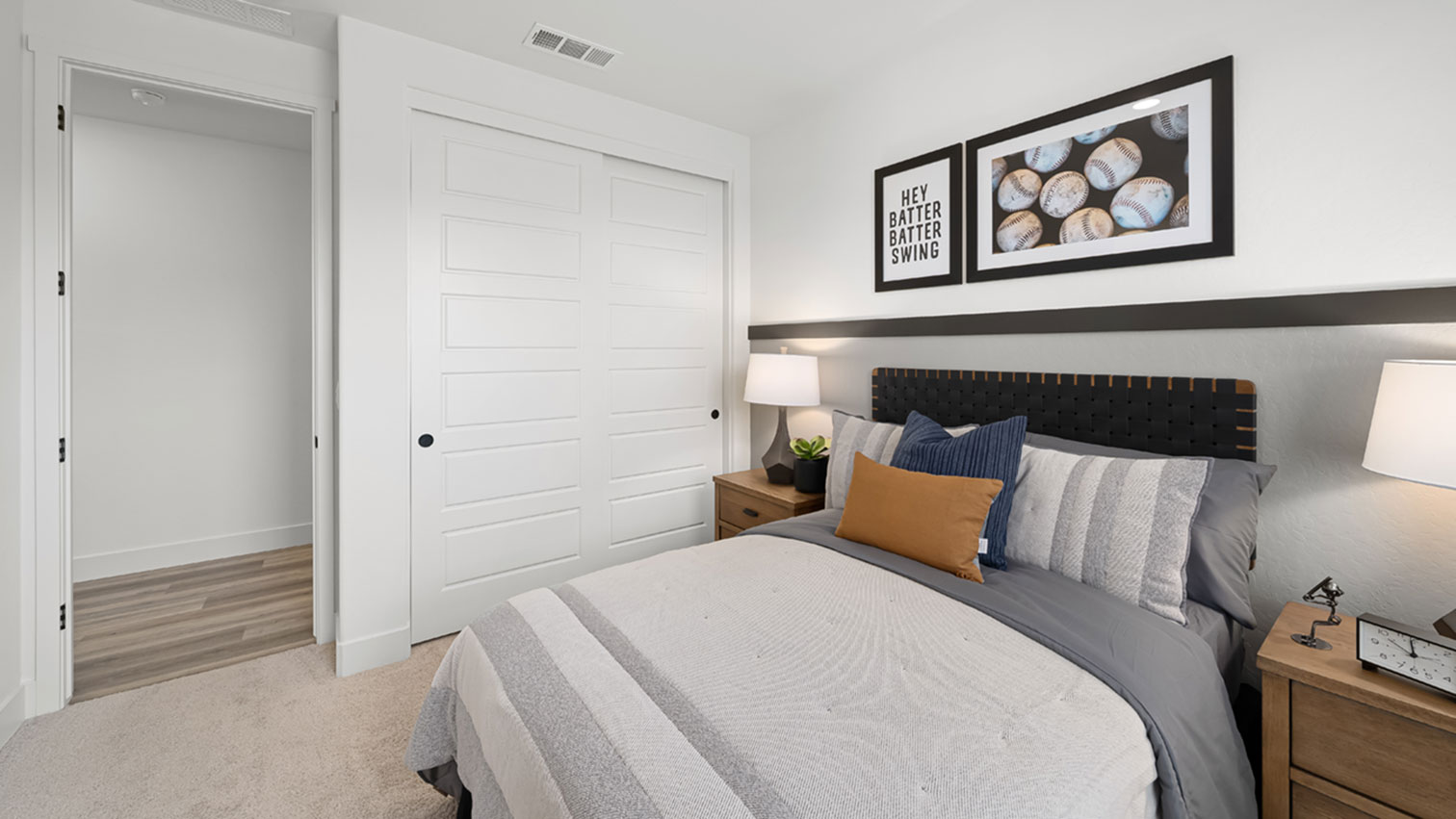 Bedroom with sliding closet doors, plush carpeting, and hallway access