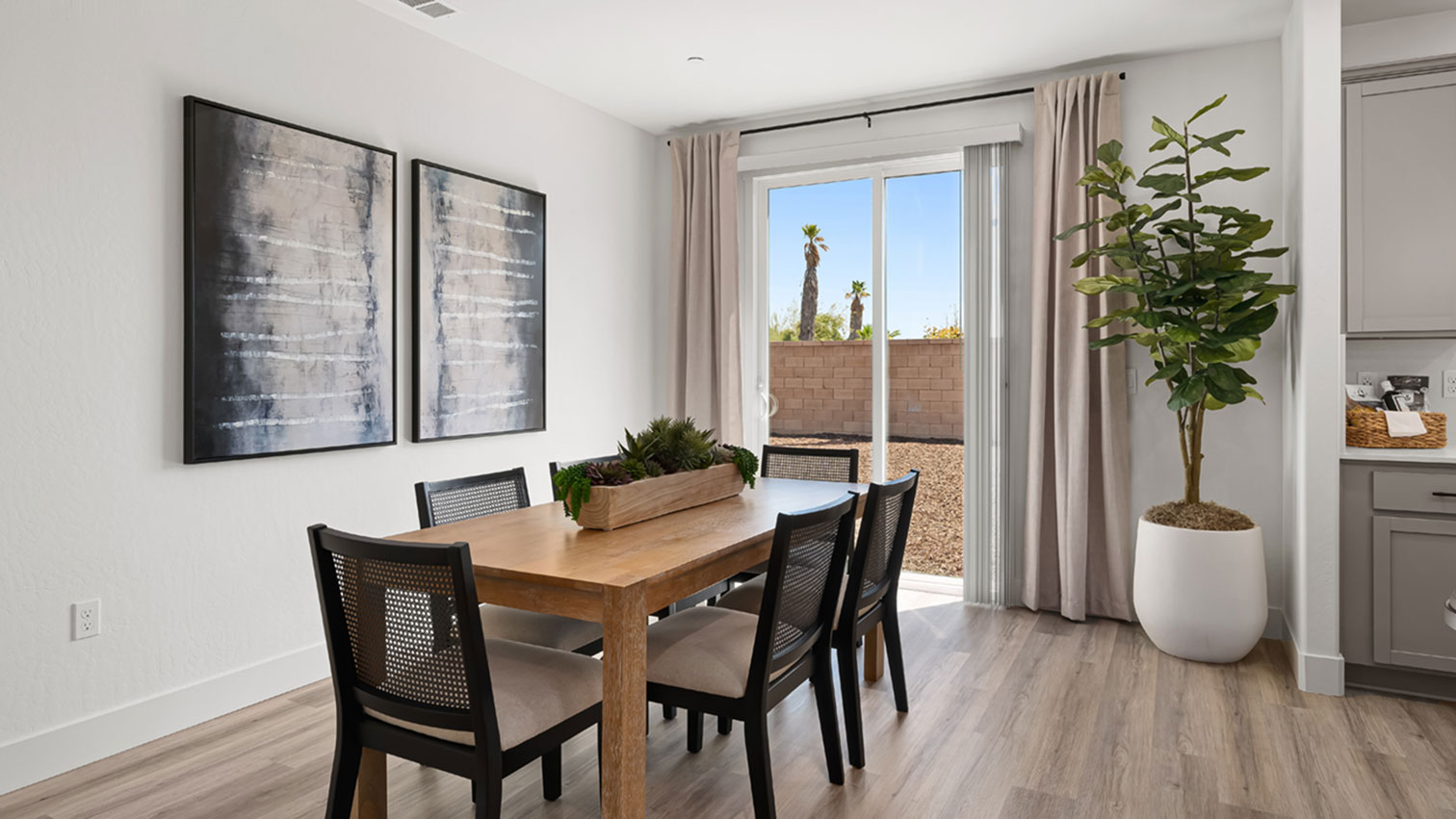 Dining area adjacent to kitchen with sliding glass door and expansive flooring