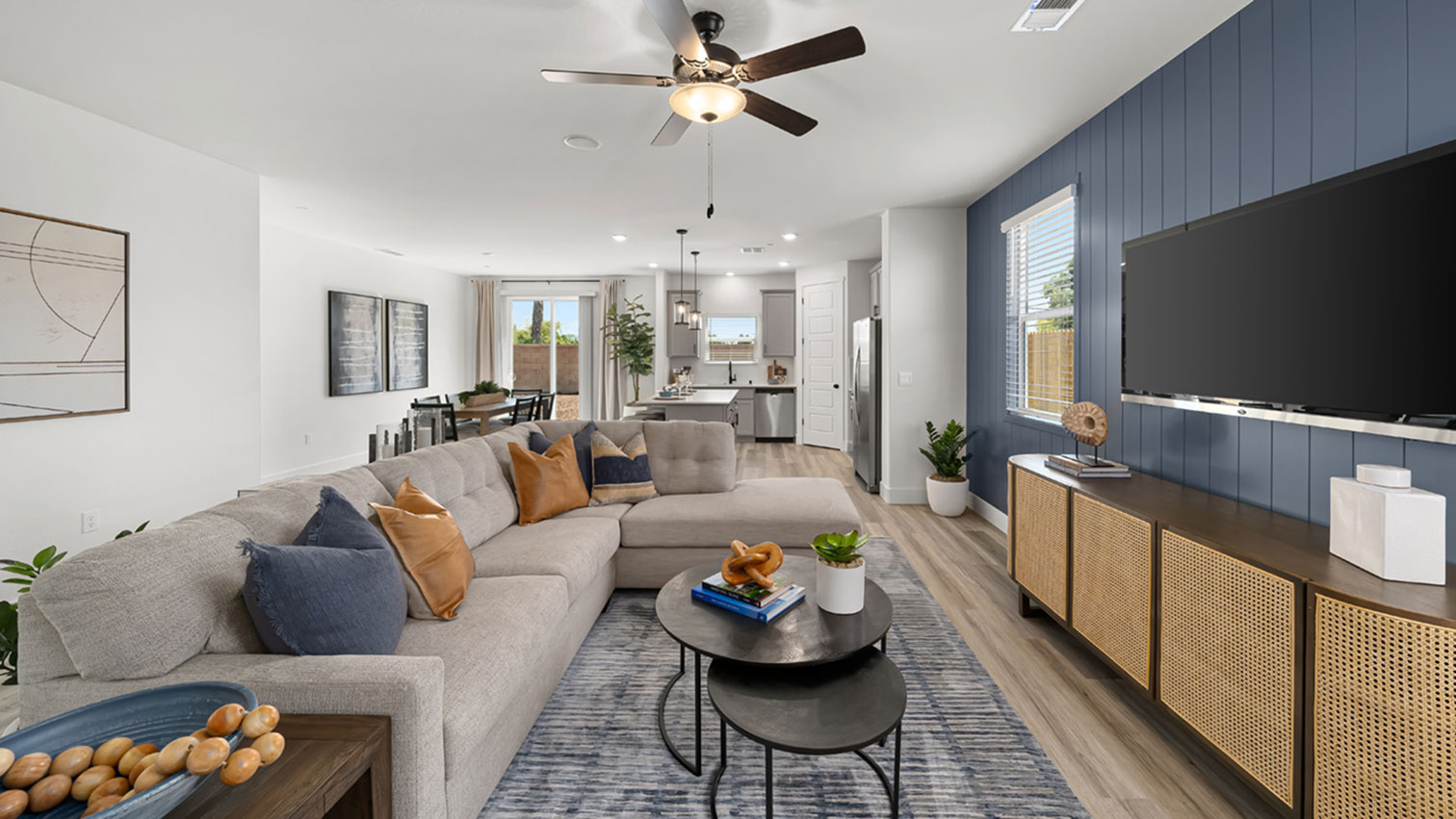 Open living area with ceiling fan, dining area, and expansive flooring