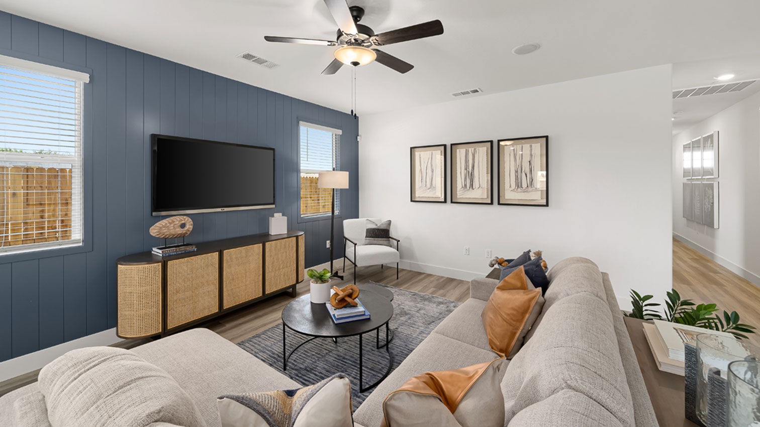 Living room with ceiling fan, and expansive flooring