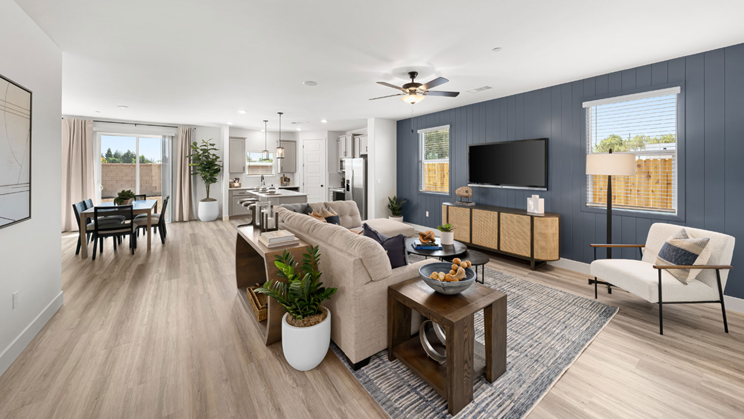 Open living, dining, and kitchen area with large sliding glass door and expansive flooring