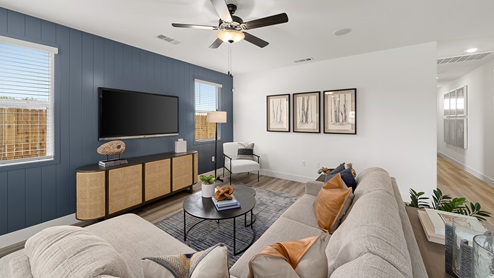 Photo of open conept living room with large couch, rug, and coffee table