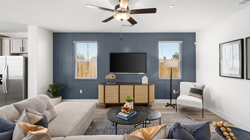 Photo of open conept living room with large couch, rug, and coffee table