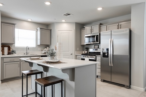 Kitchen with light cabinets and island seating