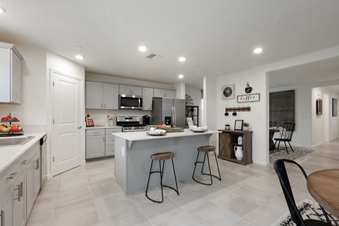 Bright kitchen with light cabinets and island seating