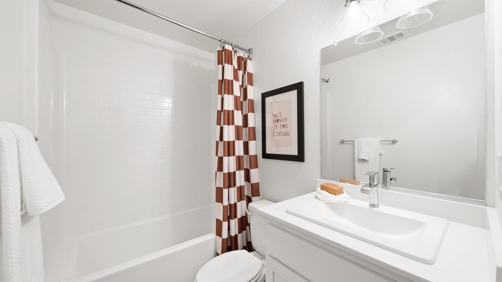 guest bathroom with white countertops and cabinets