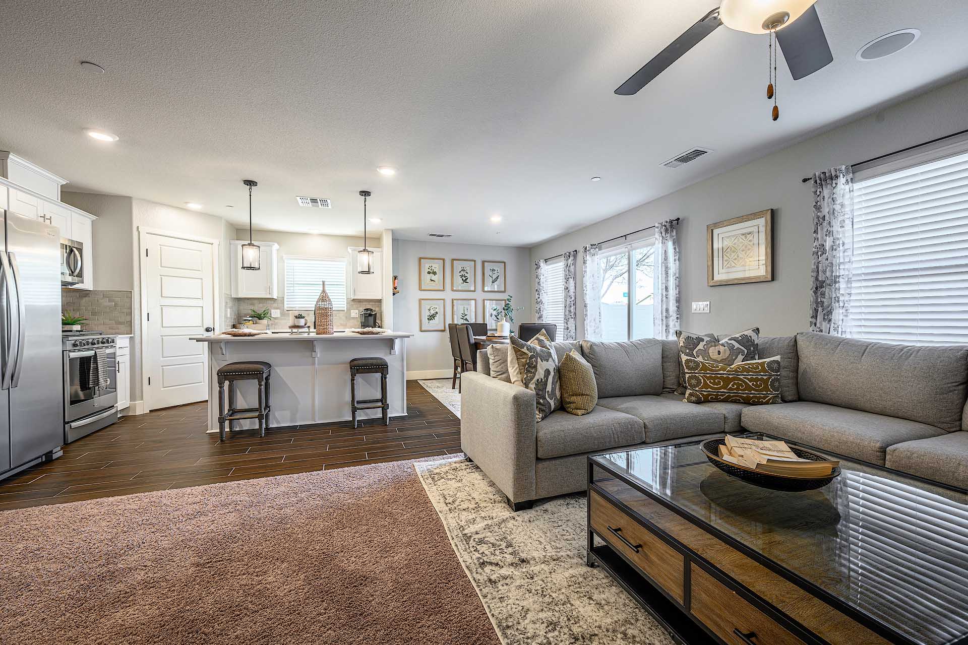 Interior photo of open concept living room with large sectional couch and coffee table.
